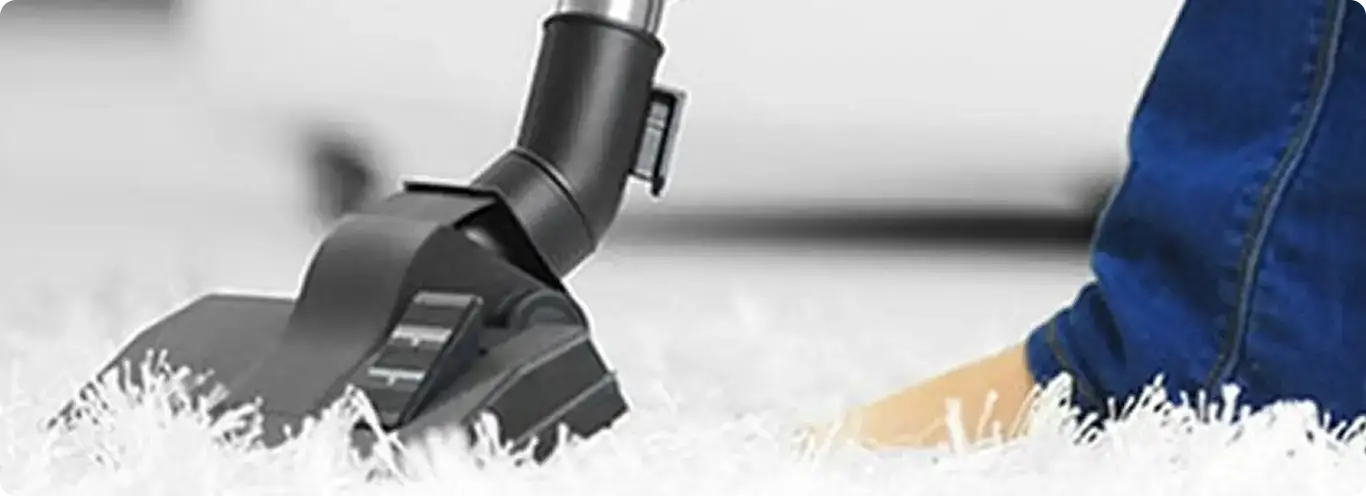 Close-up of a professional vacuuming a white carpet in Ft Mitchell.